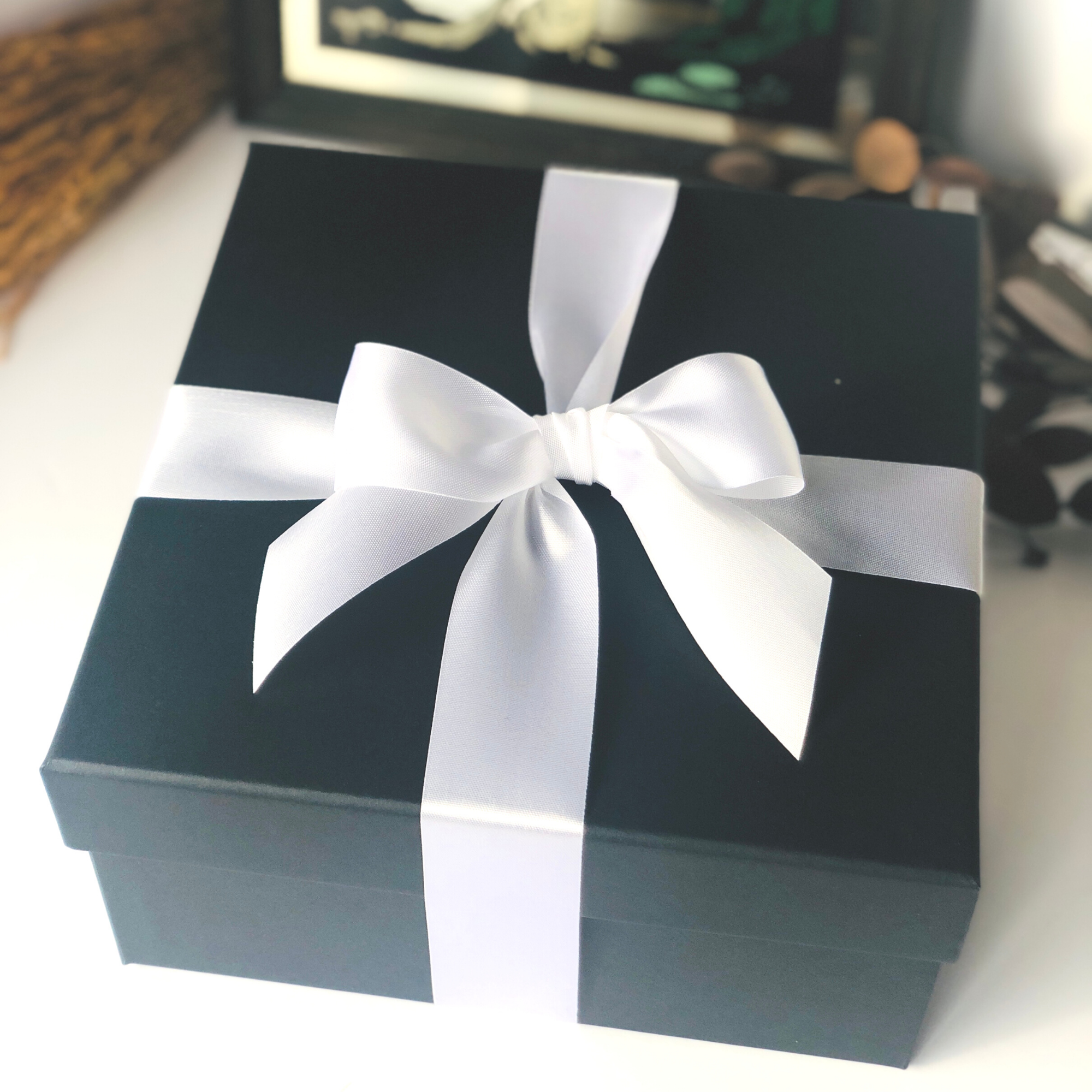 Black eco friendly gift box for her with white plastic free ribbon.